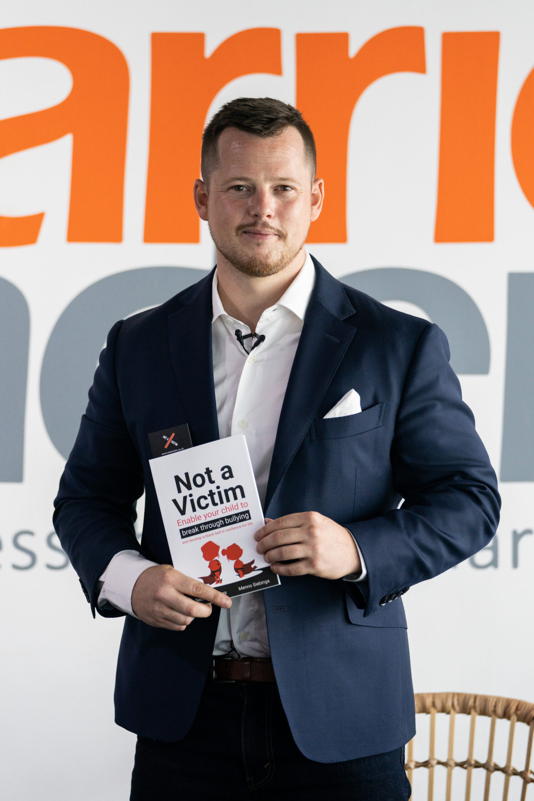 Sebastian Bates holding his book