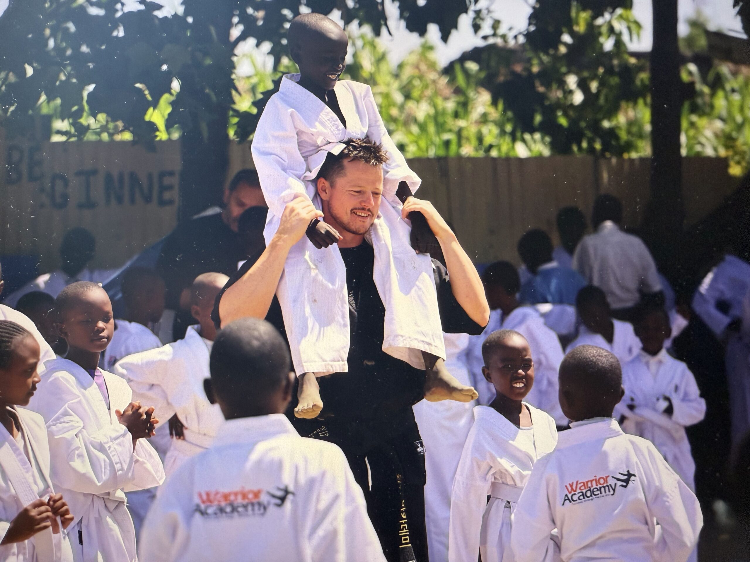 Sebastian Bates lifted up by students of The Bates Foundation in Kenya